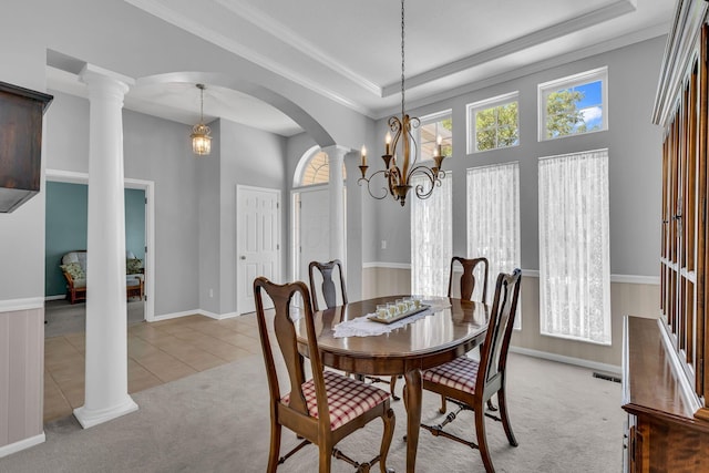 180 Locust Curve Dr, Delaware, OH 43015 - dining space with ornate columns, light colored carpet, arched walkways, a raised ceiling, and crown molding