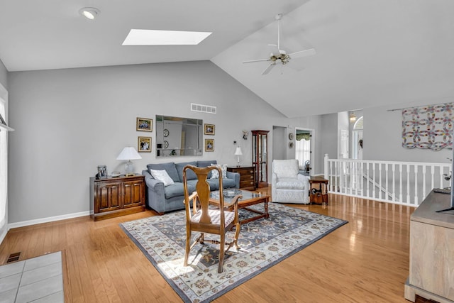 180 Locust Curve Dr, Delaware, OH 43015 - living room featuring ceiling fan, high vaulted ceiling, a skylight, and light wood-style flooring