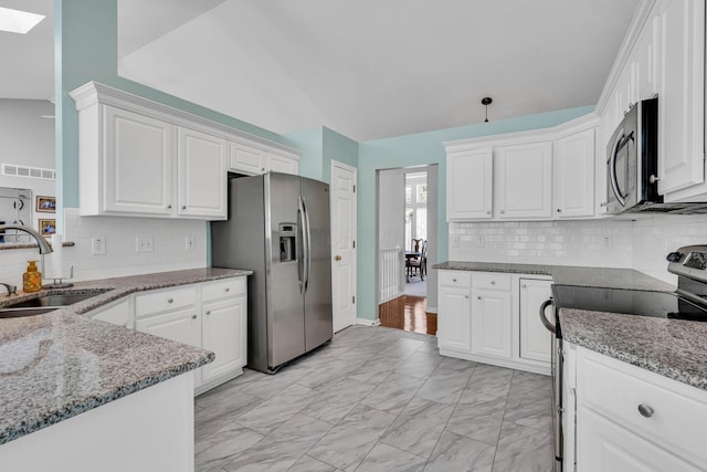 180 Locust Curve Dr, Delaware, OH 43015 - kitchen featuring stainless steel appliances, white cabinetry, light marble finish floors, tasteful backsplash, and light stone countertops