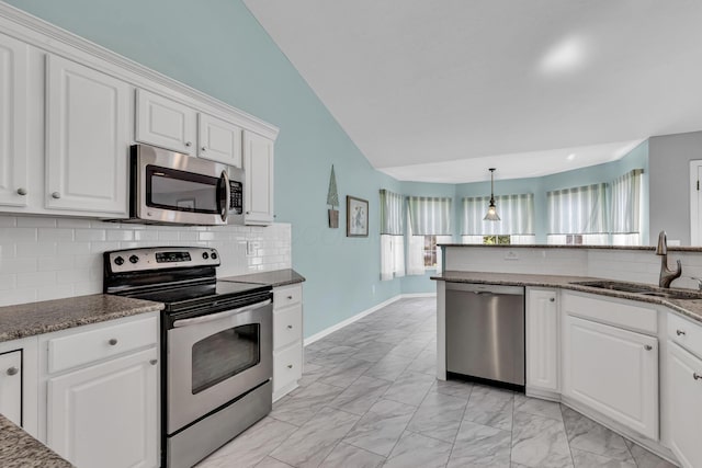 180 Locust Curve Dr, Delaware, OH 43015 - kitchen with appliances with stainless steel finishes, light marble finish floors, white cabinets, decorative backsplash, and lofted ceiling
