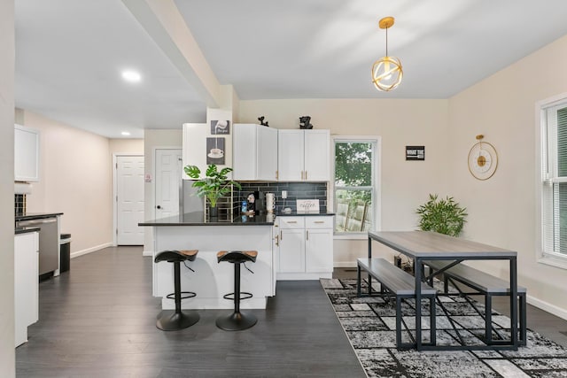 185 S Princeton Ave, Columbus, OH 43223 - kitchen featuring dishwasher, dark countertops, white cabinetry, a peninsula, and backsplash