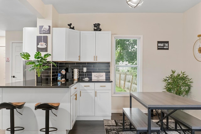 185 S Princeton Ave, Columbus, OH 43223 - kitchen featuring tasteful backsplash, white cabinetry, plenty of natural light, and dark wood-style flooring