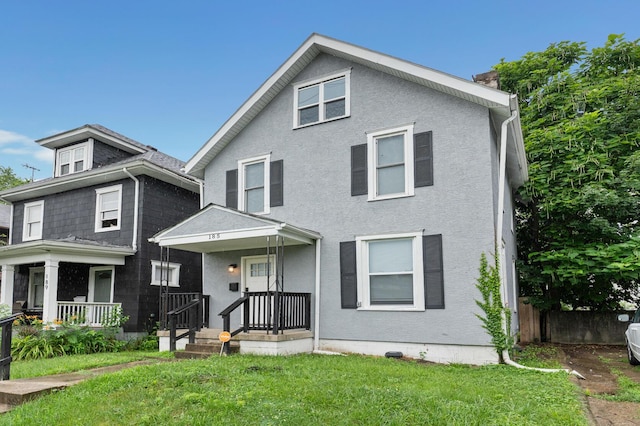 185 S Princeton Ave, Columbus, OH 43223 - view of front of home with a chimney, a front yard, and stucco siding
