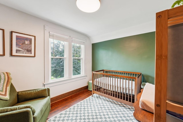 745 W Rich St, Columbus, OH 43222 - bedroom featuring wood finished floors and a crib