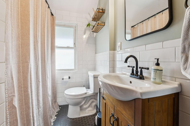 745 W Rich St, Columbus, OH 43222 - bathroom with tile walls, vanity, tile patterned flooring, and a wainscoted wall