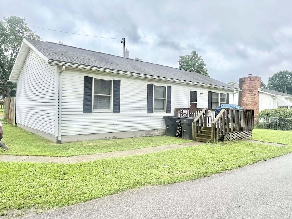 304 N Canal St, Sugar Grove, OH 43155 - manufactured / mobile home featuring a wooden deck, a front lawn, and roof with shingles