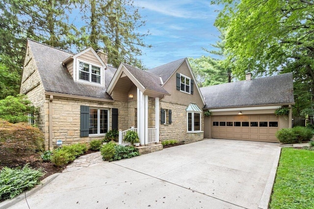116 W Royal Forest Blvd, Columbus, OH 43214 - view of front of home with a chimney, stone siding, an attached garage, driveway, and a shingled roof