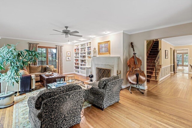 116 W Royal Forest Blvd, Columbus, OH 43214 - living area with stairway, wood finished floors, a ceiling fan, a fireplace, and crown molding