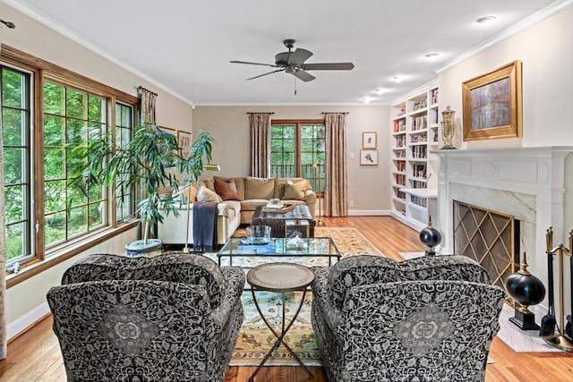 116 W Royal Forest Blvd, Columbus, OH 43214 - living area featuring ceiling fan, light wood-style flooring, a high end fireplace, and crown molding