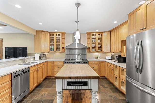 116 W Royal Forest Blvd, Columbus, OH 43214 - kitchen featuring appliances with stainless steel finishes, wall chimney range hood, stone tile flooring, butcher block countertops, and recessed lighting
