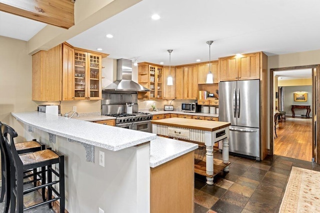 116 W Royal Forest Blvd, Columbus, OH 43214 - kitchen featuring appliances with stainless steel finishes, wall chimney range hood, a peninsula, recessed lighting, and a breakfast bar area