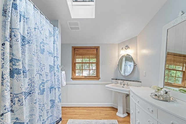 116 W Royal Forest Blvd, Columbus, OH 43214 - bathroom with wood finished floors and a wainscoted wall