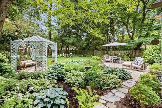 116 W Royal Forest Blvd, Columbus, OH 43214 - fenced backyard with a gazebo, a patio, and view of wooded area