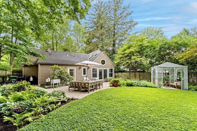 116 W Royal Forest Blvd, Columbus, OH 43214 - rear view of house featuring a patio, a chimney, a shingled roof, and a gazebo