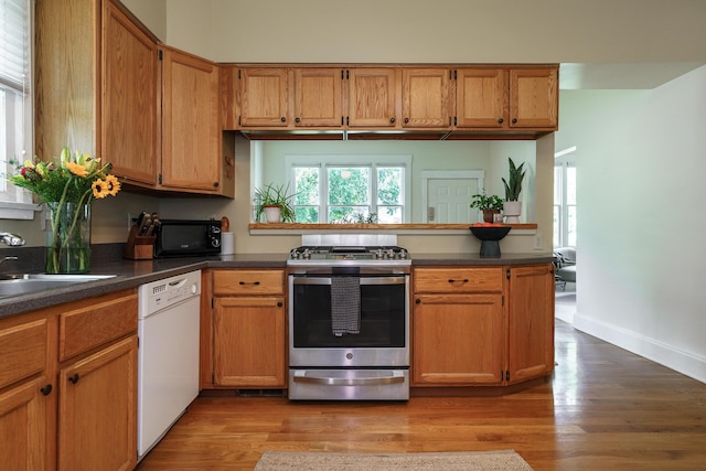 1734 W 1st Ave, Grandview, OH 43212 - kitchen with stainless steel range with gas stovetop, white dishwasher, black microwave, and dark countertops