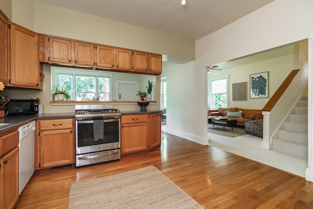 1734 W 1st Ave, Grandview, OH 43212 - kitchen featuring stainless steel range with gas cooktop, white dishwasher, black microwave, dark countertops, and open floor plan