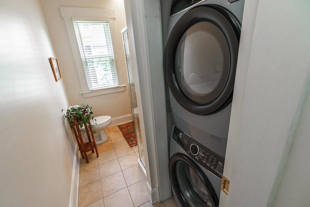 1734 W 1st Ave, Grandview, OH 43212 - laundry area with stacked washer / drying machine and light tile patterned floors