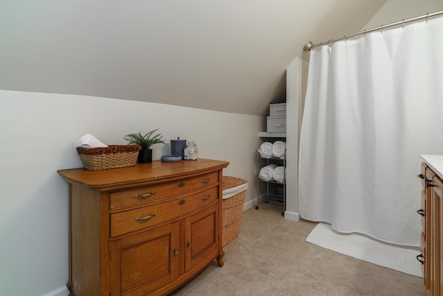 1734 W 1st Ave, Grandview, OH 43212 - bathroom with lofted ceiling, vanity, a shower with curtain, and tile patterned flooring