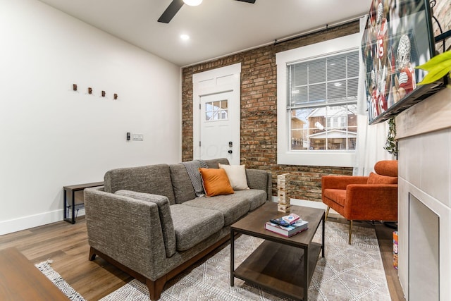 887-891 S 22nd St, Columbus, OH 43206 - living area with wood finished floors, a ceiling fan, and brick wall
