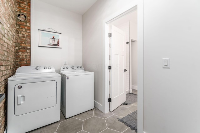 887-891 S 22nd St, Columbus, OH 43206 - laundry room featuring washing machine and clothes dryer, brick wall, and light tile patterned flooring