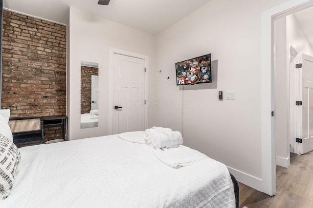 887-891 S 22nd St, Columbus, OH 43206 - bedroom with light wood-style flooring and brick wall