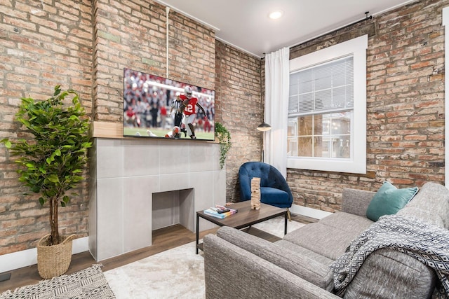 887-891 S 22nd St, Columbus, OH 43206 - living area featuring brick wall, wood finished floors, and a tiled fireplace