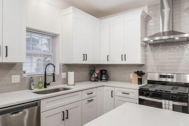 887-891 S 22nd St, Columbus, OH 43206 - kitchen featuring wall chimney range hood, stainless steel appliances, light countertops, decorative backsplash, and white cabinets