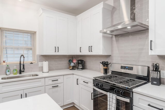 887-891 S 22nd St, Columbus, OH 43206 - kitchen featuring gas stove, wall chimney range hood, white cabinets, decorative backsplash, and light countertops