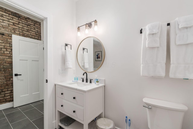 887-891 S 22nd St, Columbus, OH 43206 - bathroom with brick wall, vanity, and tile patterned floors