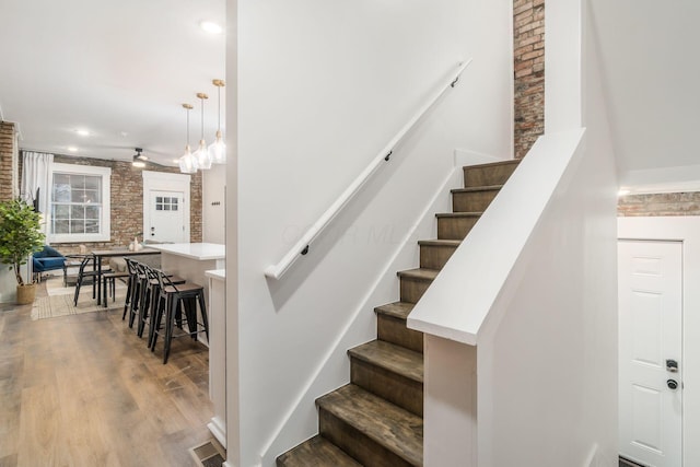 887-891 S 22nd St, Columbus, OH 43206 - stairs featuring wood finished floors, brick wall, and recessed lighting
