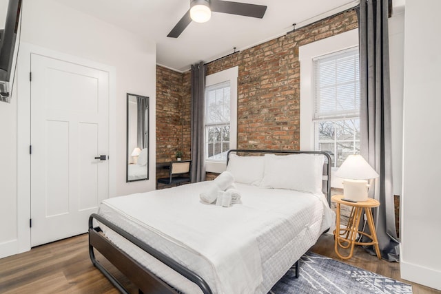 887-891 S 22nd St, Columbus, OH 43206 - bedroom featuring brick wall, wood finished floors, and a ceiling fan