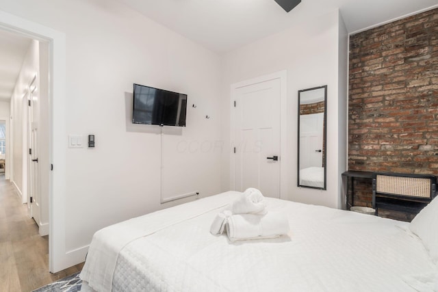 887-891 S 22nd St, Columbus, OH 43206 - bedroom with wood finished floors and brick wall
