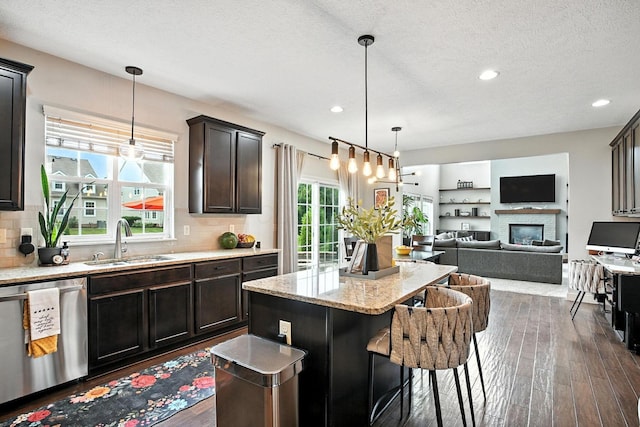 6946 Dean Farm Rd, New Albany, OH 43054 - kitchen with stainless steel dishwasher, dark wood finished floors, backsplash, a center island, and recessed lighting