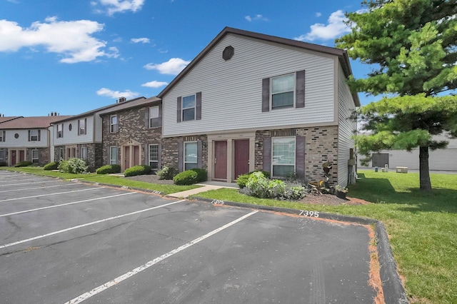 7385-7395 Cimmaron Sta, Columbus, OH 43235 - multi unit property with uncovered parking, a front lawn, and stone siding