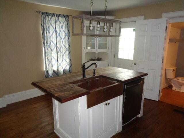 312 W William St, Delaware, OH 43015 - kitchen with dishwasher, dark wood finished floors, a kitchen island with sink, and butcher block counters