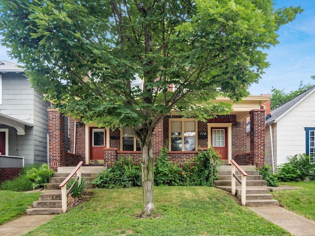 116-118 E Hudson St, Columbus, OH 43202 - obstructed view of property with brick siding and a front yard