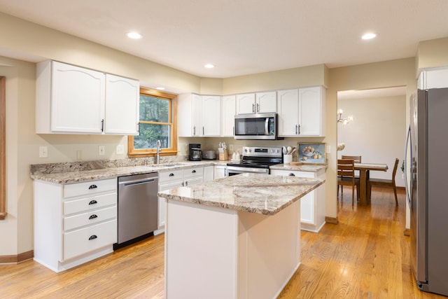 11578 Duncan Plains Rd NW, Johnstown, OH 43031 - kitchen with appliances with stainless steel finishes, light wood finished floors, light stone countertops, white cabinetry, and recessed lighting