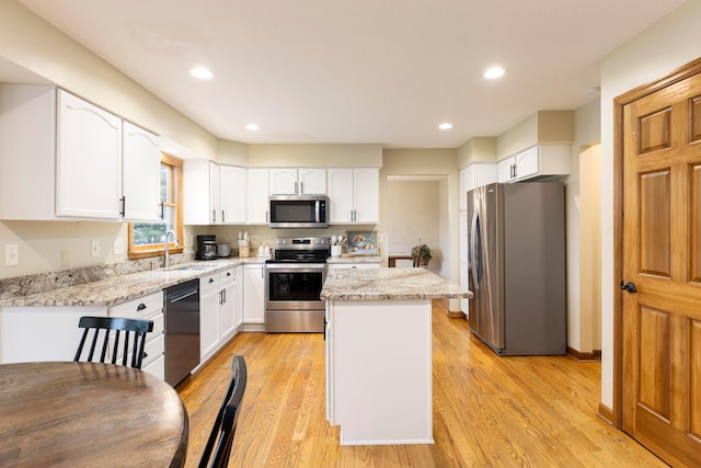 11578 Duncan Plains Rd NW, Johnstown, OH 43031 - kitchen with stainless steel appliances, a kitchen island, white cabinetry, light stone counters, and recessed lighting