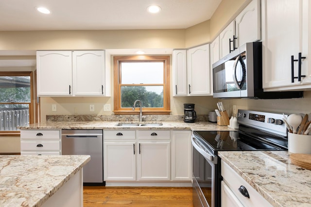 11578 Duncan Plains Rd NW, Johnstown, OH 43031 - kitchen featuring stainless steel appliances, white cabinetry, light stone countertops, and recessed lighting