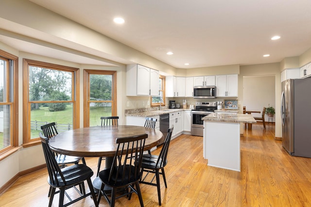11578 Duncan Plains Rd NW, Johnstown, OH 43031 - kitchen featuring stainless steel appliances, white cabinets, healthy amount of natural light, and recessed lighting