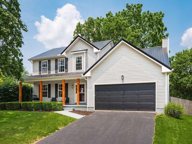 3552 Smiley Rd, Hilliard, OH 43026 - view of front facade featuring an attached garage, covered porch, driveway, a chimney, and a metal roof