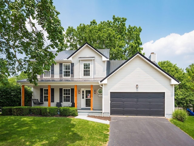 3552 Smiley Rd, Hilliard, OH 43026 - view of front of property featuring a garage, asphalt driveway, a front lawn, and a metal roof