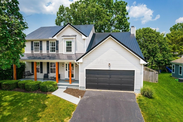 3552 Smiley Rd, Hilliard, OH 43026 - view of front of property featuring covered porch, a garage, a metal roof, asphalt driveway, and a standing seam roof