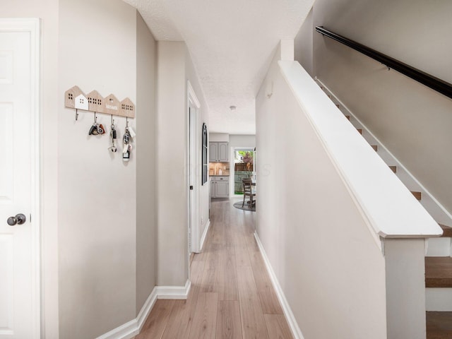 3552 Smiley Rd, Hilliard, OH 43026 - hall with light wood-style floors and a textured ceiling