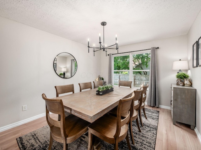 3552 Smiley Rd, Hilliard, OH 43026 - dining space featuring a chandelier, light wood finished floors, and a textured ceiling