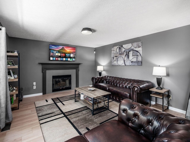 3552 Smiley Rd, Hilliard, OH 43026 - living area featuring wood finished floors, a tile fireplace, and a textured ceiling
