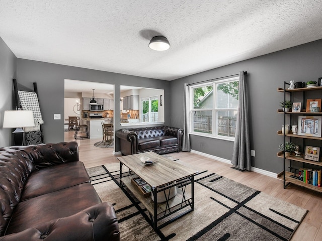 3552 Smiley Rd, Hilliard, OH 43026 - living area featuring light wood-type flooring and a textured ceiling