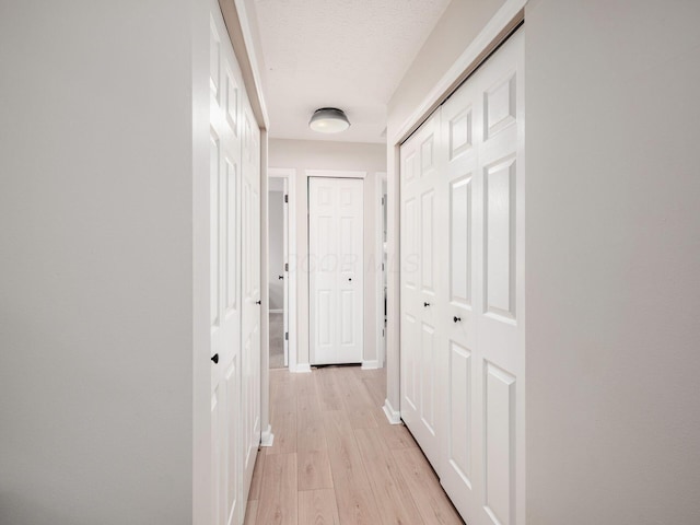 3552 Smiley Rd, Hilliard, OH 43026 - hallway featuring light wood-type flooring and a textured ceiling