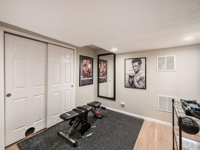 3552 Smiley Rd, Hilliard, OH 43026 - workout room with a textured ceiling, light wood-style floors, and recessed lighting