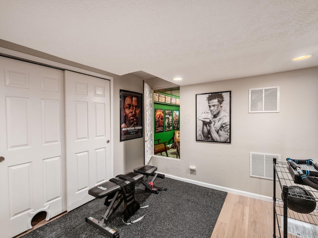 3552 Smiley Rd, Hilliard, OH 43026 - exercise room with a textured ceiling, recessed lighting, and wood finished floors